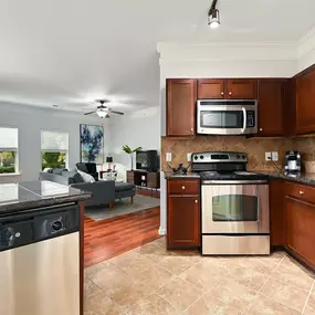 a kitchen with stainless steel appliances and wooden cabinets