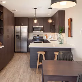 Kitchen with stainless steel appliances and dining area