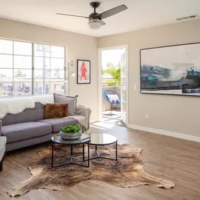 Living room with large windows and door to balcony