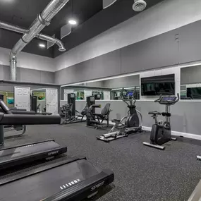 Renovated Fitness Center with cardio machines and free weights.