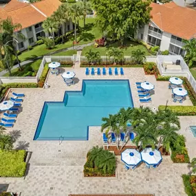 Expansive resort style pool with sundeck and lounge chairs.