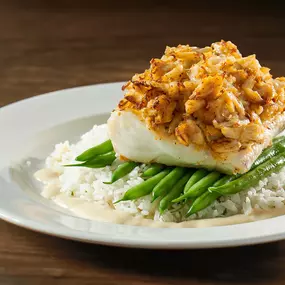 Crab crusted haddock with crab cake, lemon butter sauce, herbed jasmine rice, and seasonal vegetable.