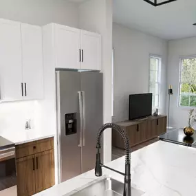 A kitchen with stainless steel appliances and white countertops