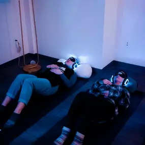 Gentle lighting and a grounded space promote mindfulness during Holotropic Breathwork therapy.