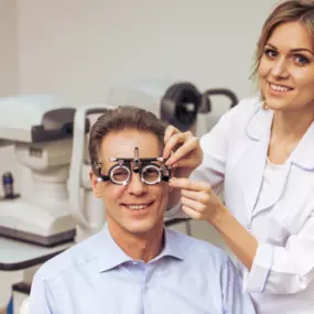 man getting his eyes examined by woman optometrist