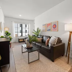 Open concept living room with luxury plank flooring and ample natural lighting.