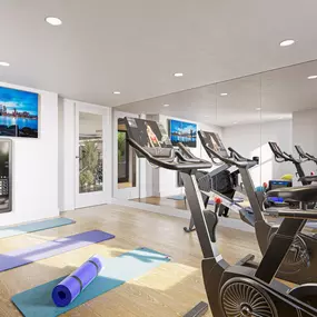 Yoga room with mats and cycling machines.