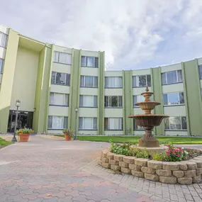 A courtyard with a fountain in front of an apartment building