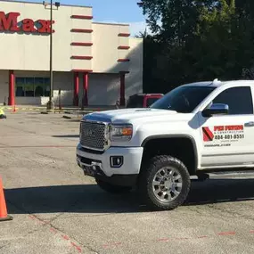 PKS Paving truck parked in front of an OfficeMax