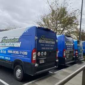 Superior Restoration Work Vans Parked in Parking Lot