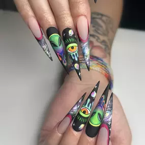 Exquisite hand-painted long nails with intricate designs.