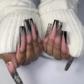 Trendy encapsulated French tip nails with unique, modern designs.