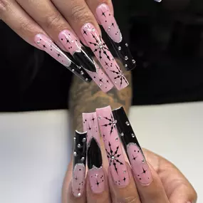 Bold black and pink heart designs on an acrylic full set for a playful, chic look.