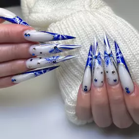 Elegant winter snowflake nail art with icy cool tones and shimmer.