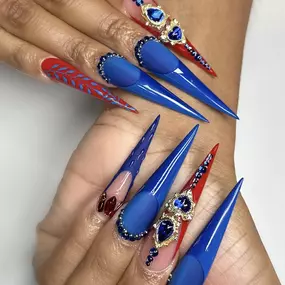 Striking royal blue long stiletto nails for a bold, fierce look.