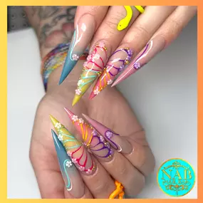 Trendy acrylic long nails with butterfly designs, perfect for a whimsical look.