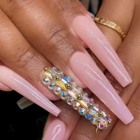 Soft bubble bath pink nails adorned with sparkling rhinestones.