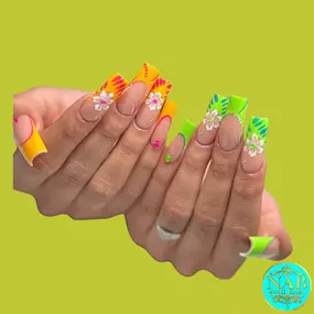 Bold neon orange and green nails with 3D floral accents for a tropical vibe.