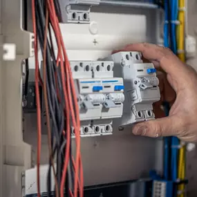 male-electrician-works-switchboard-with-electrical-connecting-cable-2048x1365.jpg