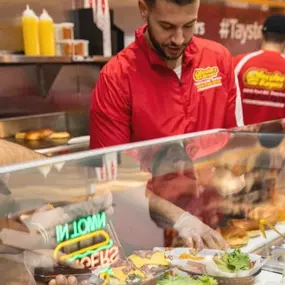 Taystee's Burgers employee building a burger