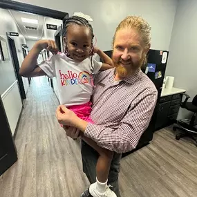 Dr. Chad McKeel holding a pediatric patient.