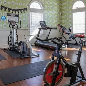 a gym with exercise equipment in a large room