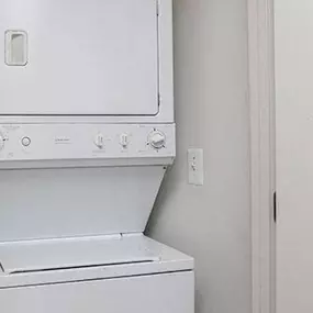 a white washer and dryer in a white room