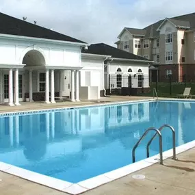 a large swimming pool in front of a building