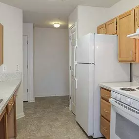 a kitchen with a stove refrigerator and sink