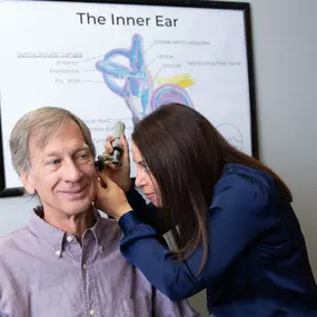 Meredith Wilken (Founder & Audiologist) conducts an ear exam