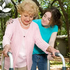 Teen girl helping a senior lady with a walker.