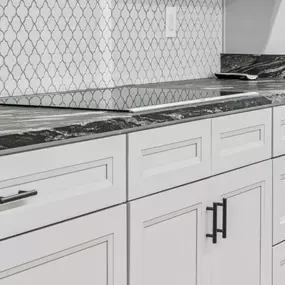 Its all in the details. This cabinet, hardware, backsplash, and countertop combination creates timeless beauty!