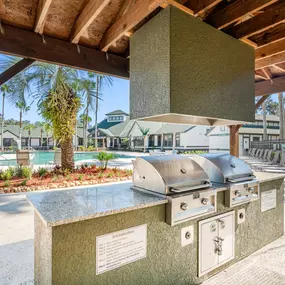 Spacious covered outdoor grilling station with countertops.