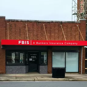 Red brick one story storefront of our Albemarle, NC insurance agency office.