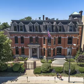an aerial view of a brick building with an flag at The Knights @ 506 Delaware Apartments, New York, 14202