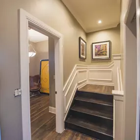 the landing of a staircase in a home with wood floors and white walls at The Knights @ 506 Delaware Apartments, Buffalo, NY 14202
