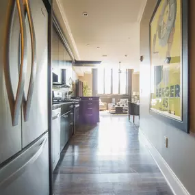 a view of a kitchen and a living room from a hallway at The Knights @ 506 Delaware Apartments, Buffalo, NY