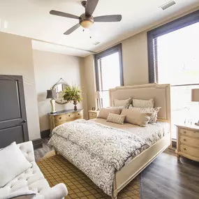 a bedroom with a bed and a ceiling fan at The Knights @ 506 Delaware Apartments, Buffalo, New York