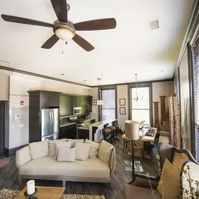 a living room and kitchen with a couch and a ceiling fan at The Knights @ 506 Delaware Apartments, New York