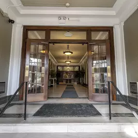 a view of the entrance to the lobby of a building with glass doors at The Knights @ 506 Delaware Apartments, Buffalo, NY 14202