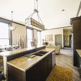 a kitchen and living room with a large counter top at The Knights @ 506 Delaware Apartments, Buffalo