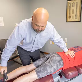 Dr. Paul Carey performing a manual adjustment on a patient