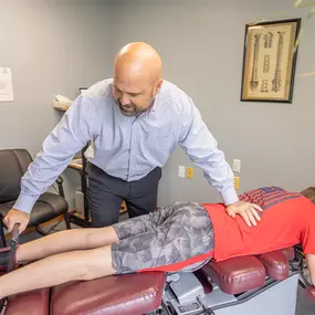 Dr. Paul Carey performing a manual adjustment on a patient