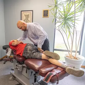 Dr. Paul Carey performing a manual adjustment on a patient