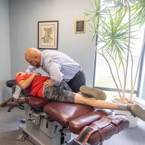 Dr. Paul Carey performing a manual adjustment on a patient