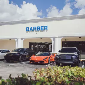 A view of the exterior of Stark's Barbershop located in Delray Beach, Florida. The image features the shop's 