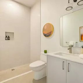 A bathroom with a white toilet and a white sink.