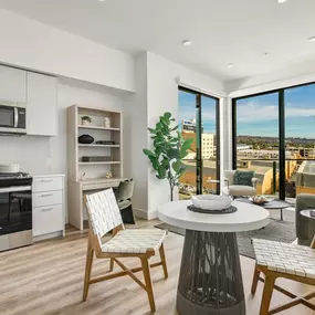 A modern kitchen with a dining table and chairs.