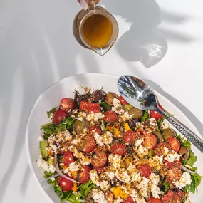 Greek Salad: Arugula, mixed greens, cherry tomato, marinated olives, cucumber, red onion, sweet bell pepper, crumbled feta, sourdough crouton crumbles, tossed in herb vinaigrette.