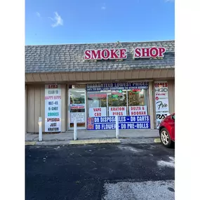 This photo showcases the **Blue Dreams Smoke Shop** storefront, featuring a prominent red and white sign with bold lettering that reads 